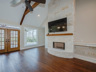 Living room of the Stone Project by LaFollette Custom Homes with wood and stone details.