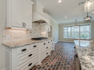 Kitchen of the Stone Project by LaFollette Custom Homes with marble countertops.