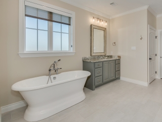 Master bath of the Stone Project by LaFollette Custom Homes with large bathtub.