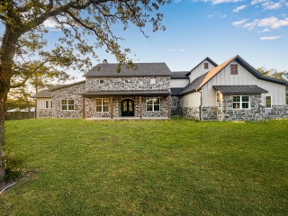 The Ball Circle Project by LaFollette Custom Homes with a stone exterior.