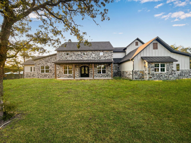 The Ball Circle Project by LaFollette Custom Homes with a stone exterior.