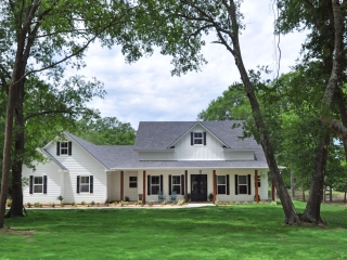 The Moore Project by LaFollette Custom Homes with a white exterior and wood accents.
