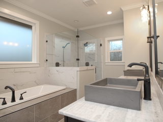 Master bath of the Farmhouse Project by LaFollette Custom Homes with marble details.