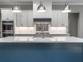 Kitchen of the Cedar Project by LaFollette Custom Homes featuring stunning blue cabinets.
