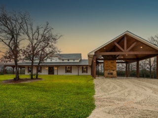 The Washburn Project by LaFollette Custom Homes with a vaulted carport.