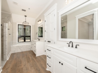 Master bath of the Silo Project by LaFollette Custom Homes with white cabinets.