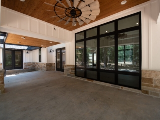 Silo Project by LaFollette Custom Homes : Rear porch with white and stone accents.