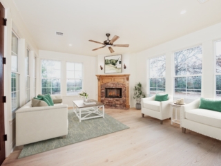 The sunroom of The Barnwood Project by LaFollette Custom Homes with white details.