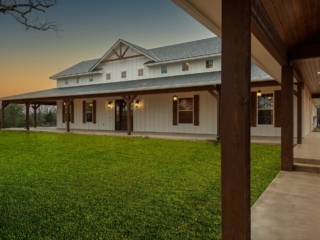 The Barnwood Project by LaFollette Custom Homes with a large porch.