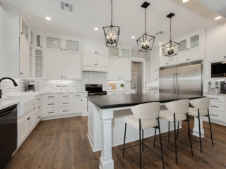 Kitchen of the Silo Project by LaFollette Custom Homes featuring white cabinets.
