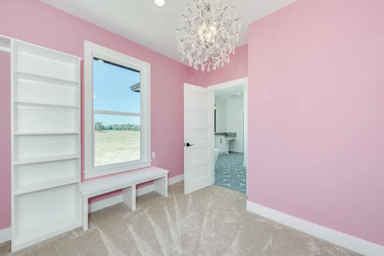 bright room with pink walls and white accent wood work
