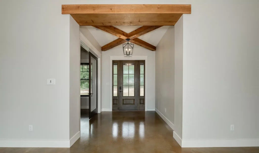 Entrance to home, dark brown door with tall windows.