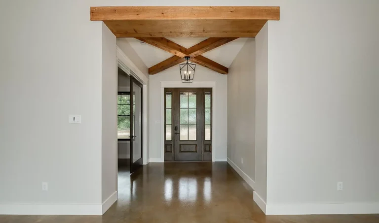 Entrance to home, dark brown door with tall windows.